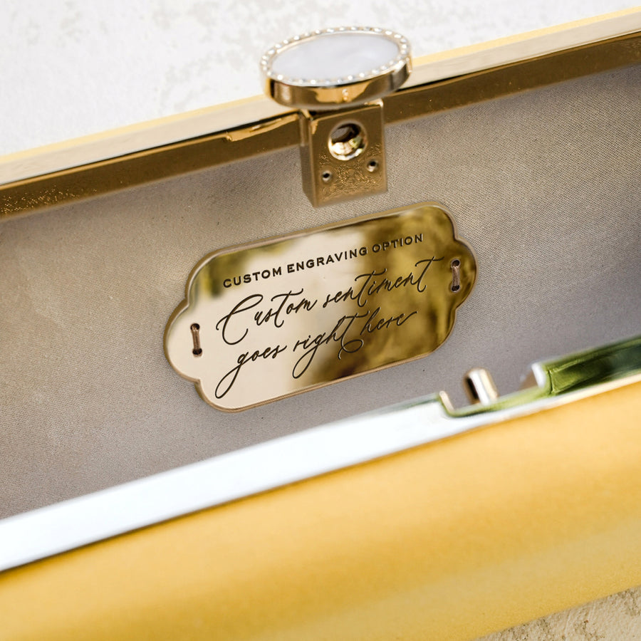 A Limoncello Yellow Satin Bella Clutch from The Bella Rosa Collection adorned with a beautiful quote inscription.