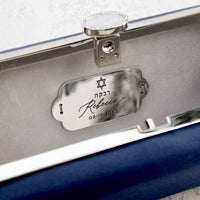 A personalized gift, the Bat Mitzvah Personalized Bella Clutch Petite from The Bella Rosa Collection is a blue leather case with a name plate on it.