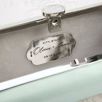 A Sage Green Satin Bella Clutch with a silver name plate from The Bella Rosa Collection.