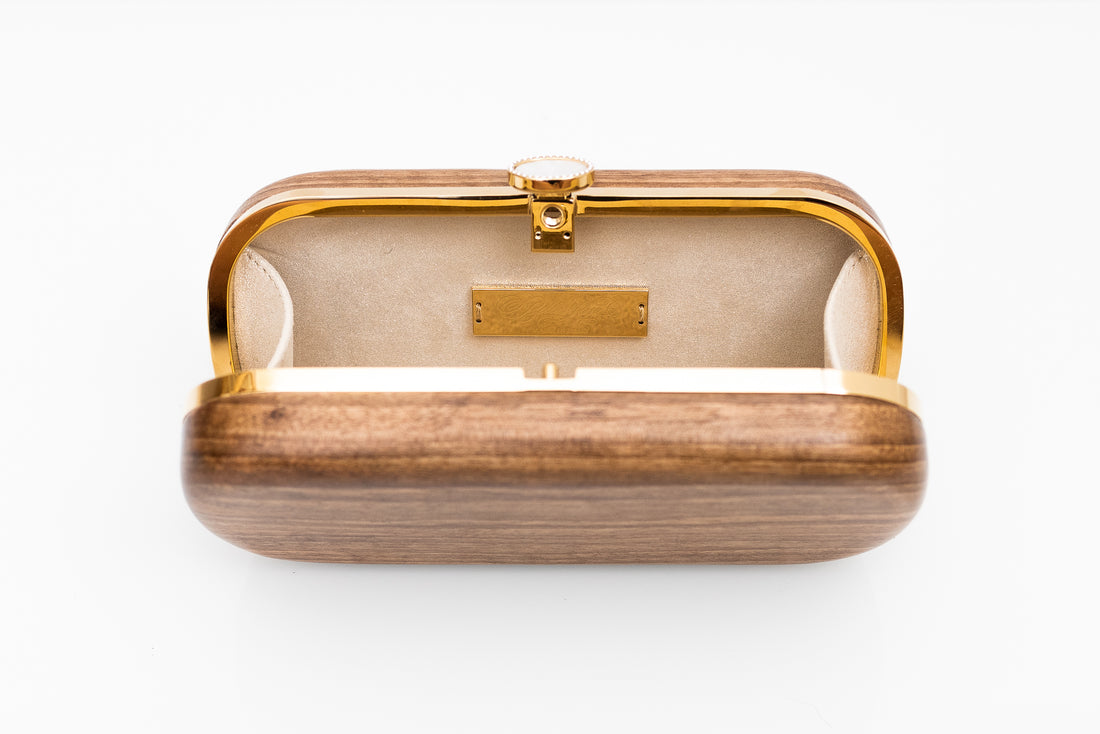 Bella Clutch with gold hardware frame in a solid Walnut Wood body.