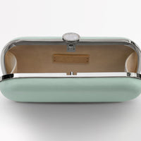 A Sage Green Satin Bella Clutch from The Bella Rosa Collection on a white surface.