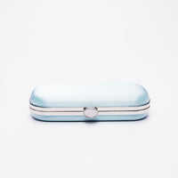 Top closed view of Bella Clutch in Cinderella Blue satin with gold hardware frame.