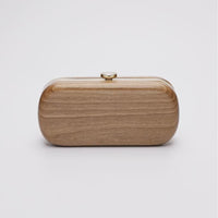 360 view of Bella Clutch with gold hardware frame in a solid Walnut Wood body.
