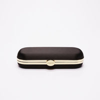 Sentence with replaced product name and brand name: The Bella Rosa Collection Bella Clutch Black Petite glasses case with gold detailing on a white background.