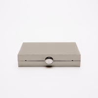 The Ella clutch in gunmetal mirror finish laying on its side to show the top c
