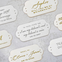 Wedding favor tags with gold lettering and the Ivory Satin Bella Fiori Clutch from The Bella Rosa Collection.