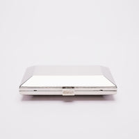 Top closed view of Milan geometric clutch in silver.