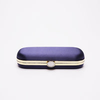 Top closed view of Bella Clutch in Navy Blue satin with silver hardware frame.