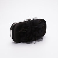Side view of Bella Fiori Clutch in black satin with black flower adored on front side.